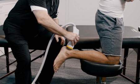 shockwave therapy being applied to a patient's ankle